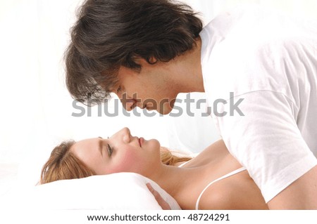 couple embracing in bed. A sensual and cute couple