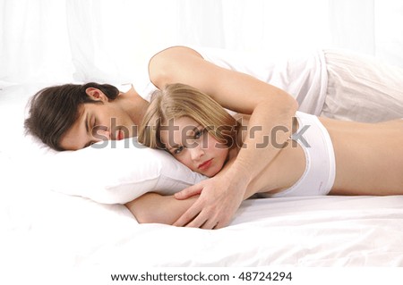 stock photo Lovely couple in bed lying in bedroom