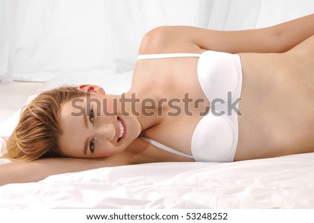 young beautiful happy woman on bed