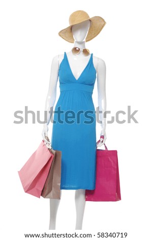 Fashion clothing on mannequin with colorful bag wearing a hat