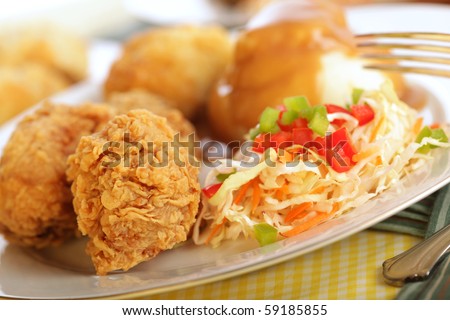 Traditional fried chicken dinner with silver fork