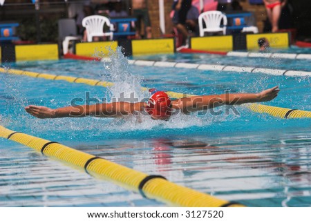 Swimming competition, man doing the butterfly stroke