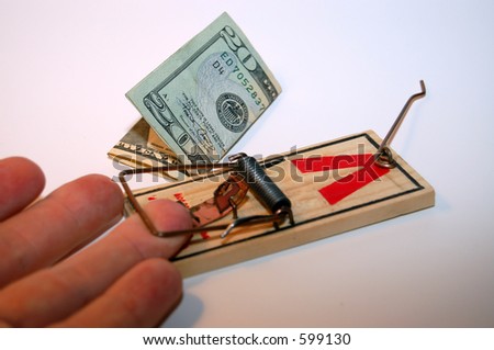 A Hand Caught In A Mousetrap with Money