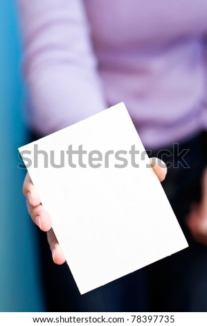 woman holds blank card in her hand. copy space for your text.