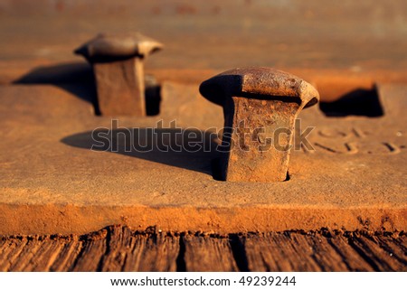 Rusty nails on a railroad track