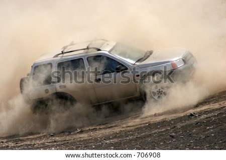 At a 4x4 event, an offroader naviagtes in deep dust and sand. South of Lima, Peru.
