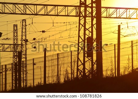 Railway electric wires and cables at sunset