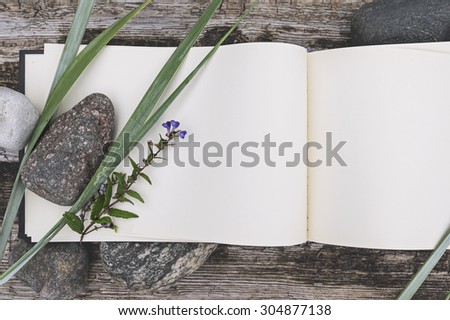 sketch book, country flowers and stones on weathered wood, mock up