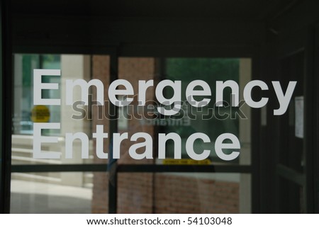 Emergency Entrance sign on sliding glass door.