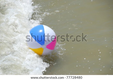 colorful beach ball washing up at the ocean surf st. augustine beach florida usa