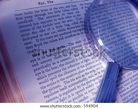 Description of eye in book with magnifying glass