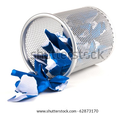 A silver mesh waste paper bin with blue paper spilling from it