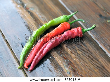 Pepper. Red and green pepper. Peppers on a wooden table.