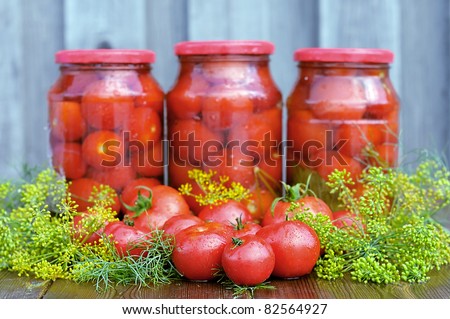 Tomatoes. Canned tomatoes. Glass jars with tomatoes. Vegetables on the table. Vegetable for the winter.