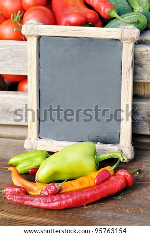 Products on the market. Pepper and the price tag in a wooden frame. Price list for food.