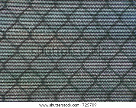 CHAIN LINK FENCE WITH NETTING AT BASEBALL FIELD