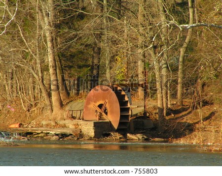 OLD WATER WHEEL ON EDGE OF CREEK WITH DAM