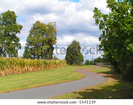 Open space public park that allows farmer to continue to grow crops; the path system weaves around the farmer\'s fields.