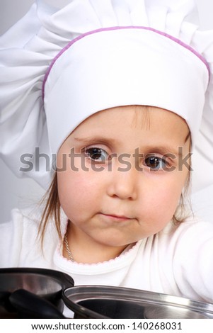 pretty little baby in a cook cap