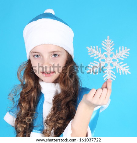 pretty little Snow Maiden with a snowflake in her hand