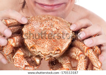 very happy man going to eat a big crab
