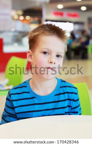 little boy in the cafe