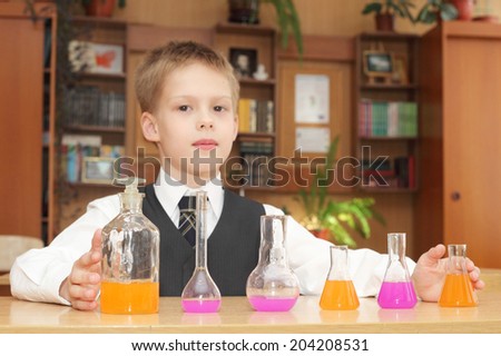 cute little boy with the pink chemical agent tubes, focus on the tubes