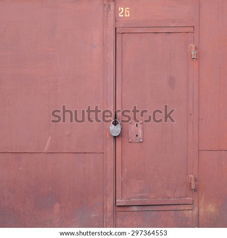 red garage gate with a padlock