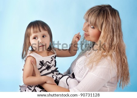 cute pretty little child showing to the mother nose