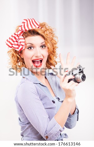 Portrait of elegant retro style woman/housewife with photo camera.