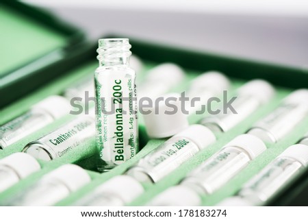 Closeup of open bottles with homeopathic remedies. Belladonna pills. Selective focus. Focus on bottle.