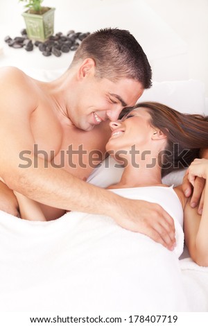 Young romantic couple in love lying in bed.