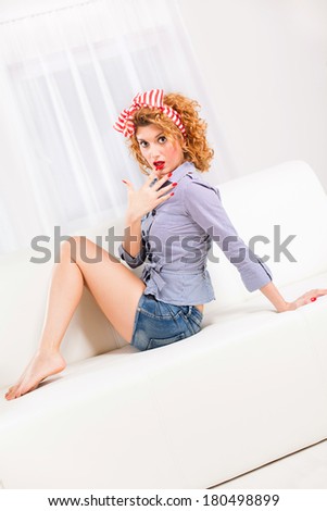 Elegant retro style woman/housewife on the sofa