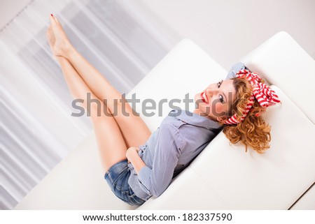 Elegant retro style woman/housewife laying on the sofa.