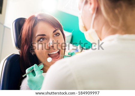 Smiling woman at dentist sitting in dentist chair ready for a dental check-up.