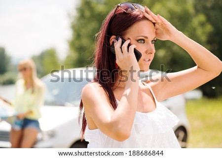 Young Tourist Woman Making Phone Call and asking for direction, because she is lost on the road.
