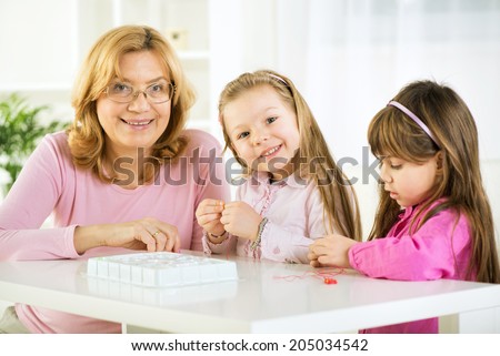 Two Young girls making bead bracelets