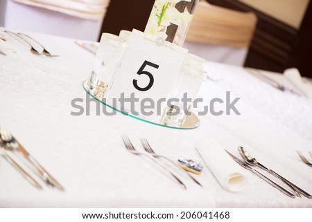Place setting and card on a table at a wedding reception