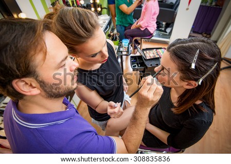 Makeup teacher helping students training to become makeup artist