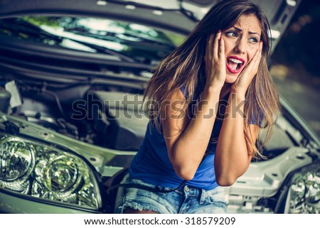 Beautiful girl screaming with despair when realizing that her car broke down.