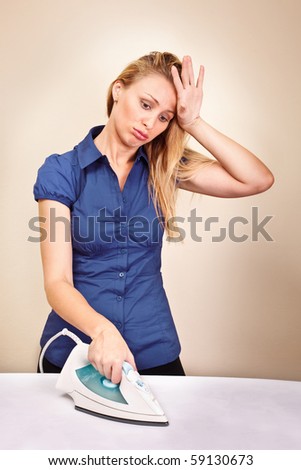 Beautiful housewife fed up of ironing