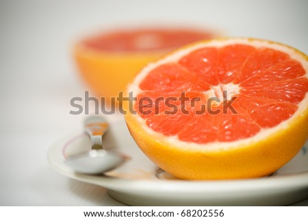 Halved red grapefruit on plate