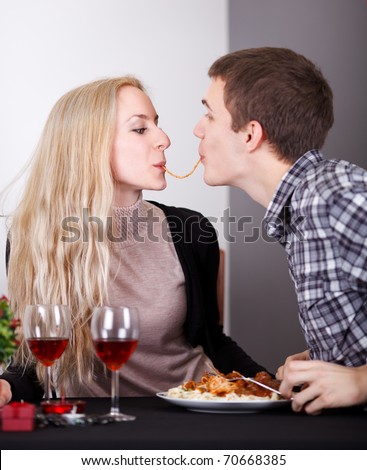 stock-photo-young-couple-sharing-a-spaghetti-on-romantic-diner-70668385.jpg