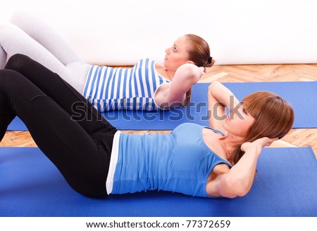 Two Fitness girl doing abs exercise