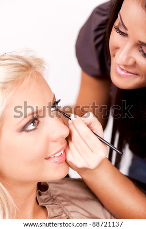 stock photo : Make-up artist applying makeup on beautiful woman