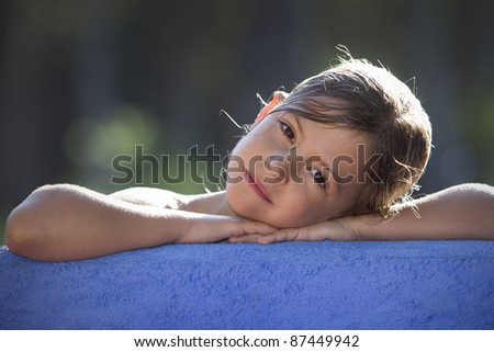 Girl resting head on wall and looking pensive