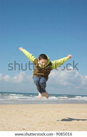 Active boy on the beach on nice winter day
