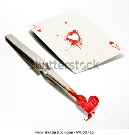 Some tweezers holding a paper heart, just removed from an ace of hearts.