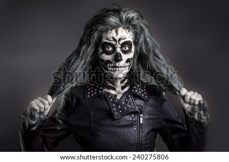 Women painted as skeleton. Halloween theme