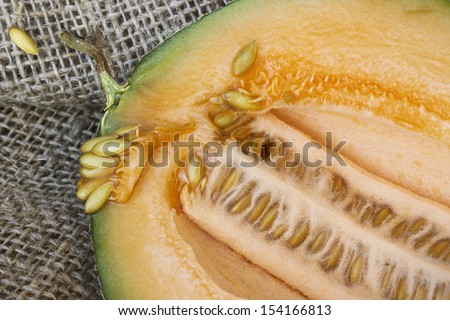 Small muscat yellow fleshed melon cut in half
